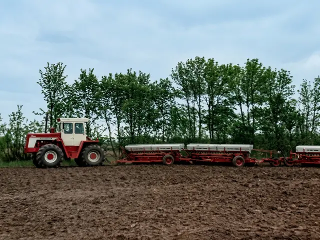 Tractor with farm equipment working the fields